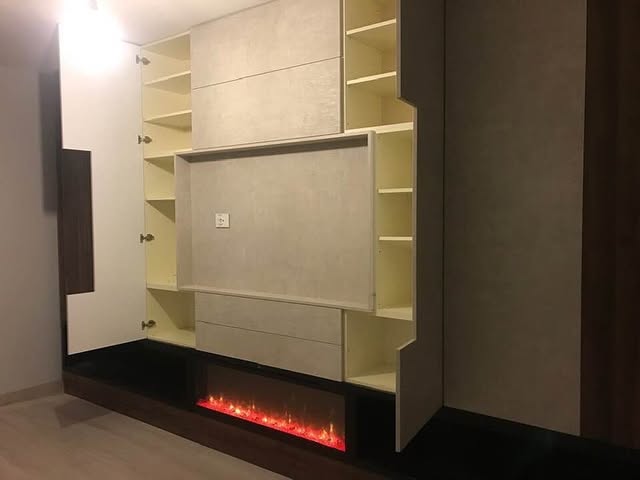 Media wall with fireplace — Built-in shelving and a linear fireplace framed in dark timber.