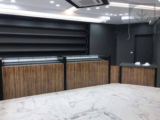 Reception counter — A commercial fit-out in dark timber over marble.