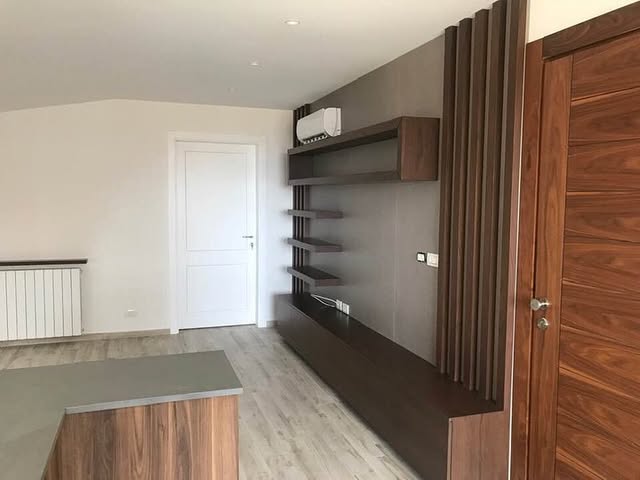 Shelving and joinery — Floating shelves and full-height joinery in a single walnut run.